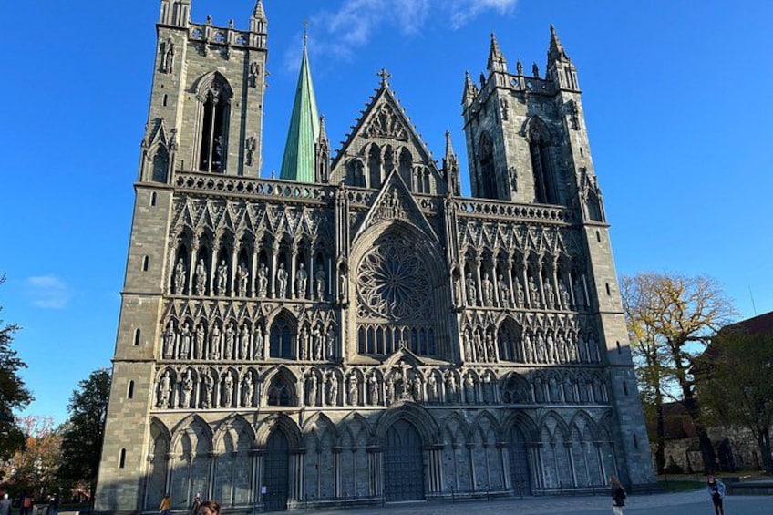 A large Gothic cathedral with twin spires, a large rose window, and intricate stonework. 2