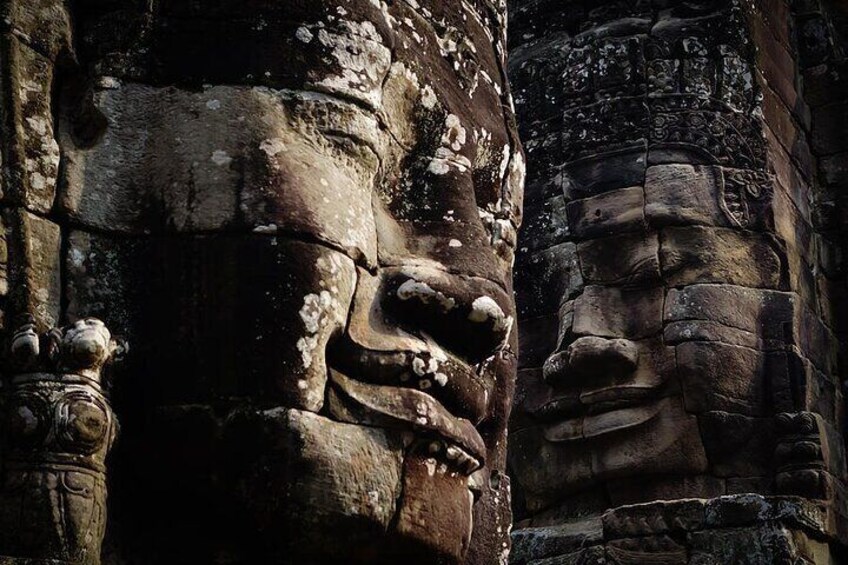 A stone face with intricate carvings, part of an ancient structure. 2
