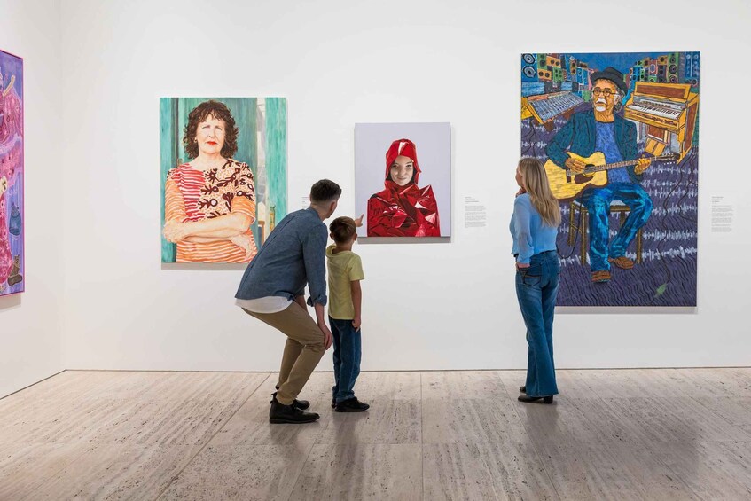 An art gallery with three paintings on display. 4