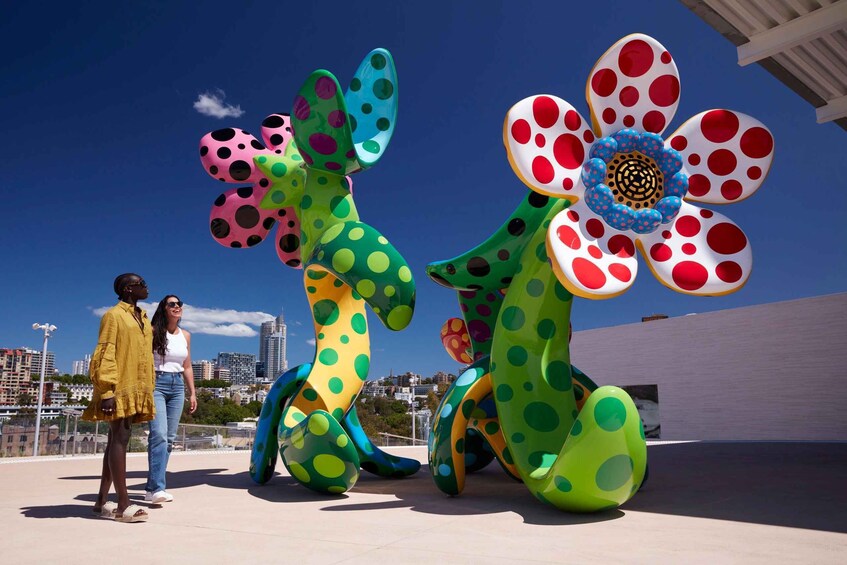 Two large, colorful, polka-dotted sculptures resembling flowers or insects. 1