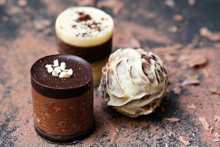 Three chocolate desserts on a textured surface. 2