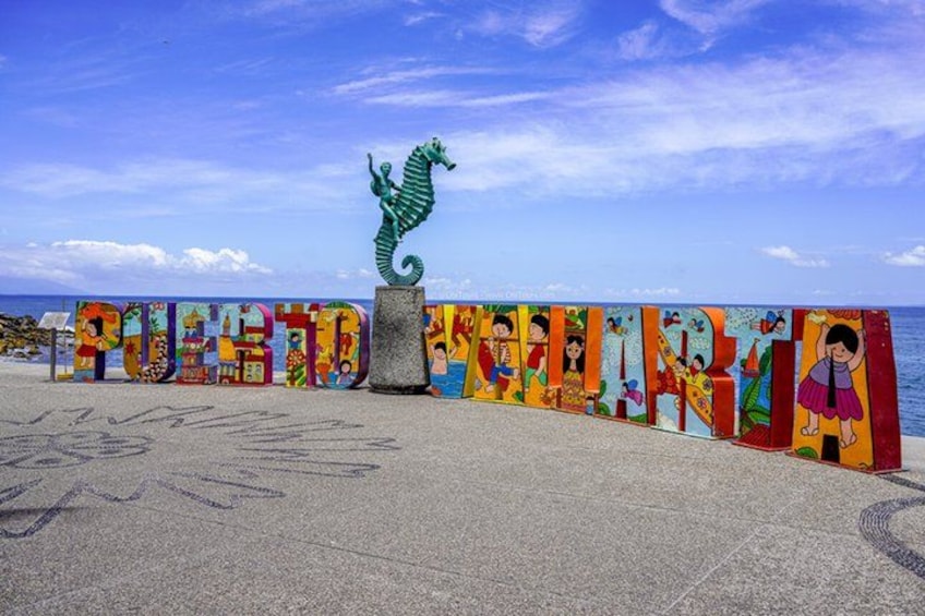 A colorful mural with the word 'PUERTO RICO' and a seahorse sculpture. 4