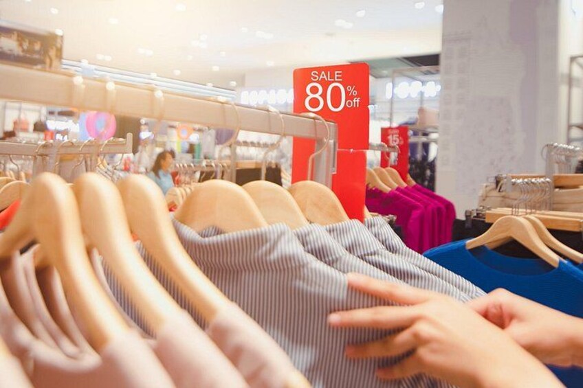 Clothing racks with a sale sign indicating 80% off. 2