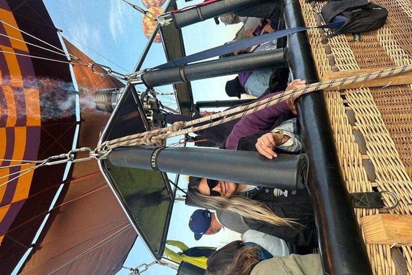Een luchtballon met passagiers, vastgemaakt aan de mand. 3