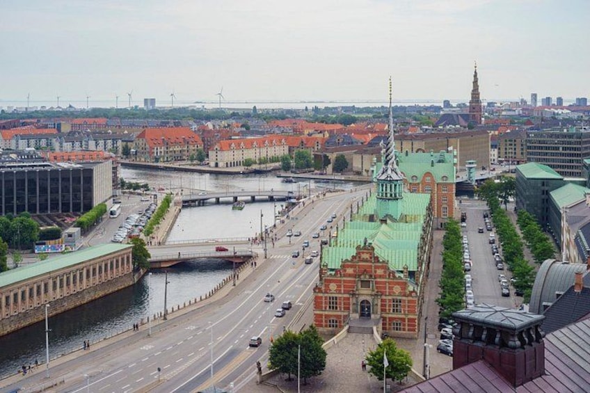 A cityscape with a prominent church, a river, and a bridge. 4