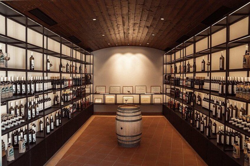 A wine cellar with wooden shelves and barrels. 5