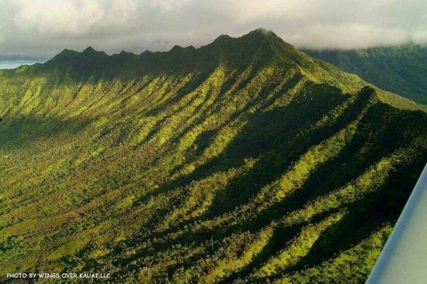 A mountainous landscape with distinct ridges and lush greenery. 2