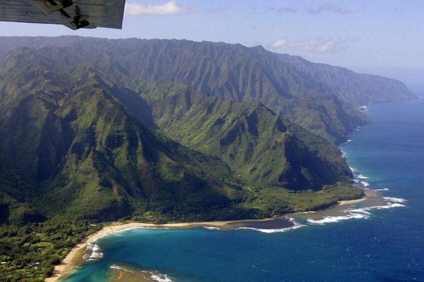 A coastal mountain range with a beach and ocean. 4