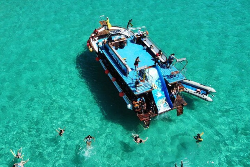 A floating platform with people swimming and standing around. 2
