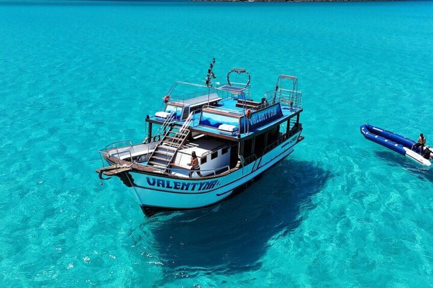 A boat named 'ValentY' on clear turquoise water. 5