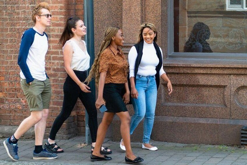 A group of people walking on a sidewalk. 3