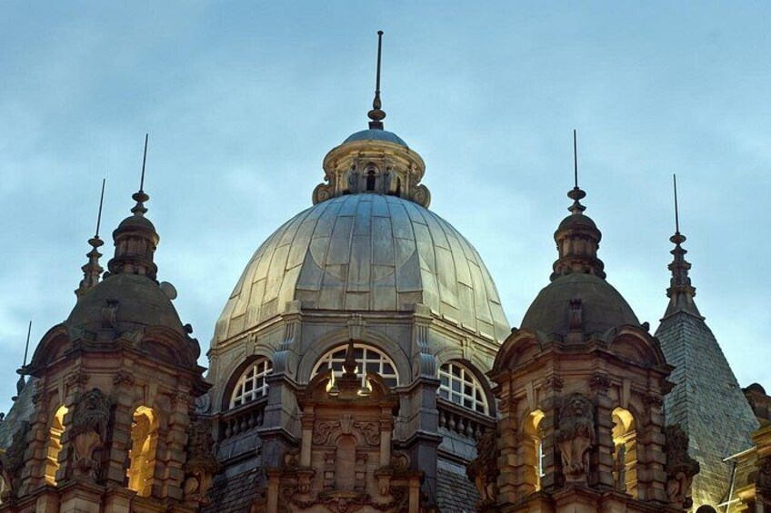 A large domed building with ornate architectural details and multiple spires. 1