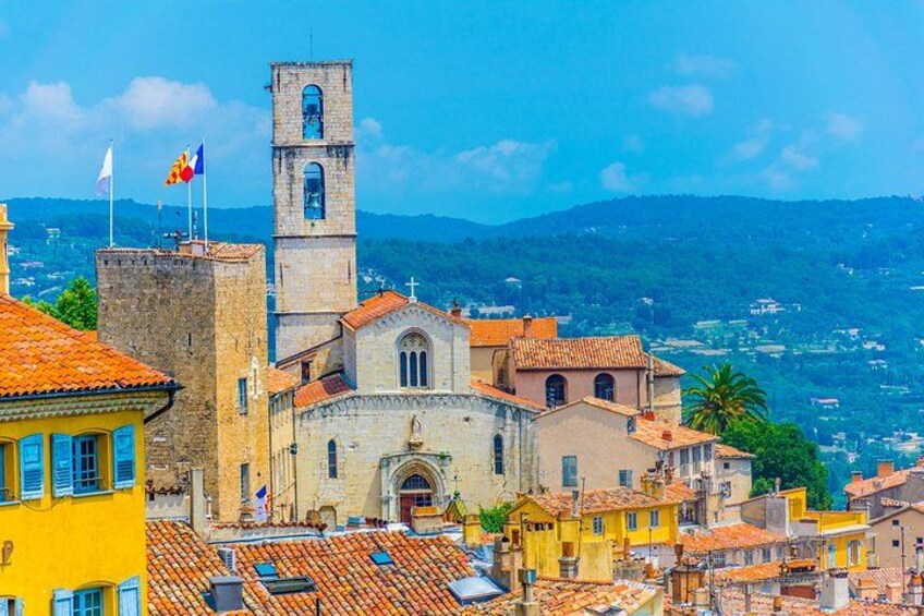 A historic town with a prominent church, a bell tower, and a clear view of the surrounding landscape. 1