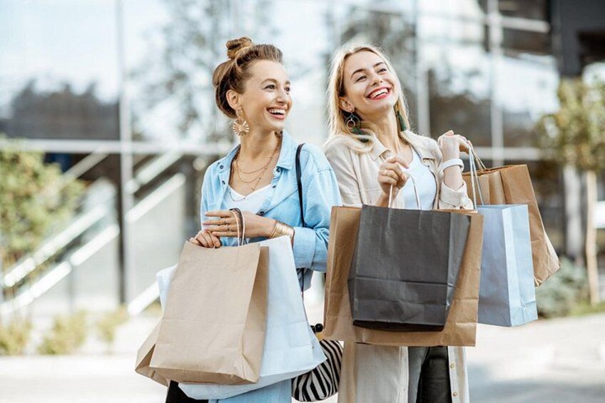 Two people holding shopping bags. 2