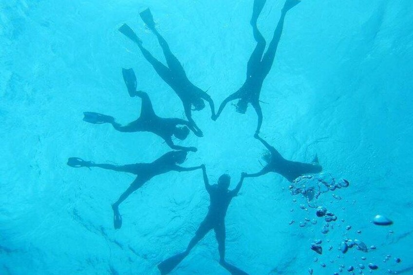 A diver's silhouette against a blue background. 2
