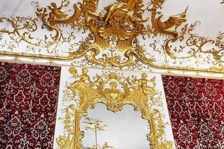 Ornate gold and white architectural details, including a decorative arch and intricate patterns. 4