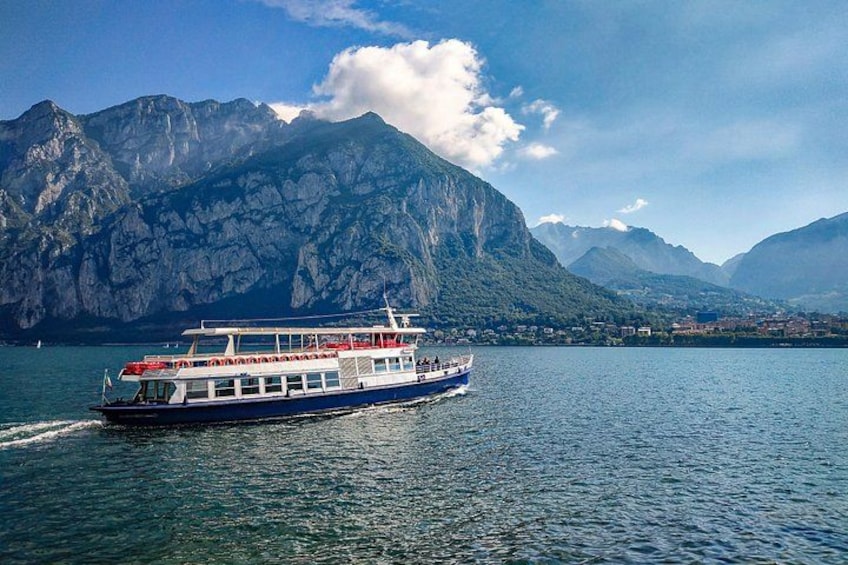 A boat on a lake with mountains in the background. 3