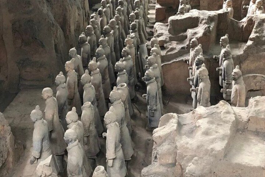 A large number of stone statues in a cave. 2