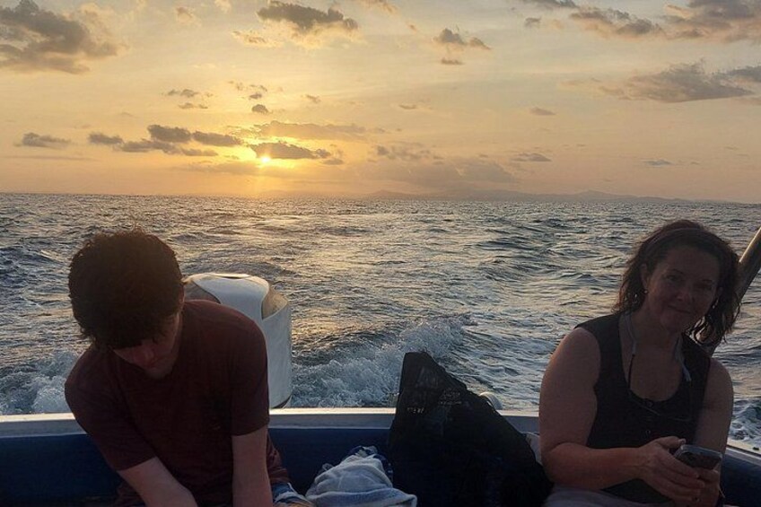 Two people on a boat at sunset. 3