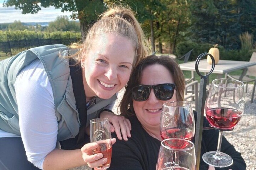 Two people sitting outdoors with wine glasses. 3