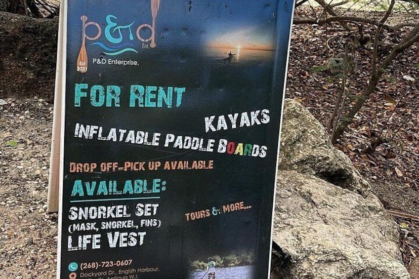 A rental sign for kayaks and paddleboards with contact information. 3