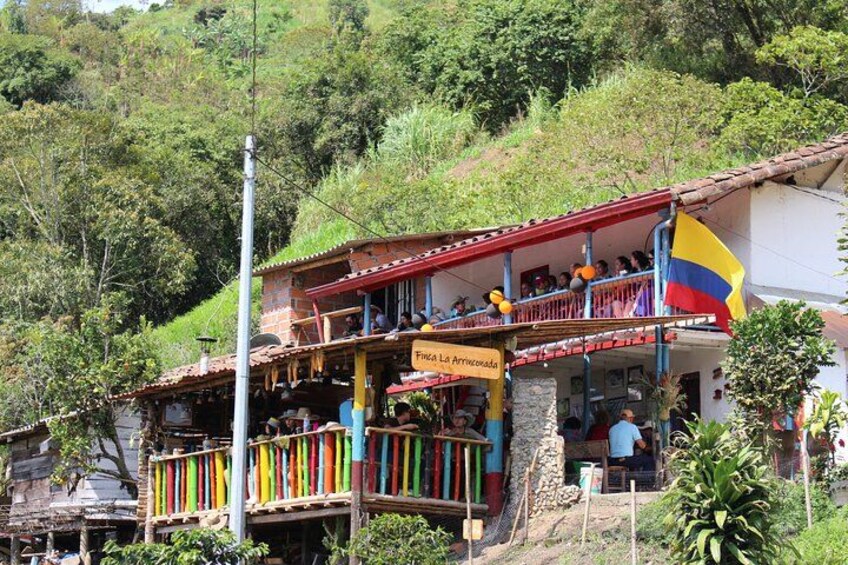 A building with a balcony, a flag, and a sign. 3
