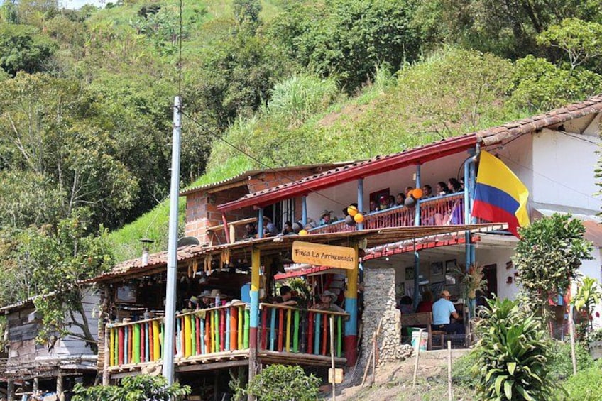 A building with a balcony, a flag, and a sign. 3