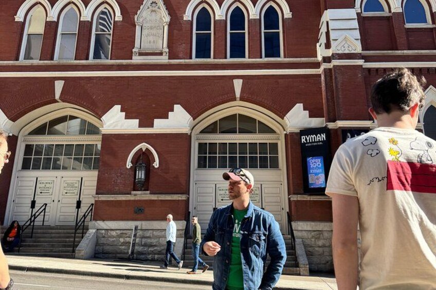 A historic building with arched windows and a sign reading 'RYMAN.' 4