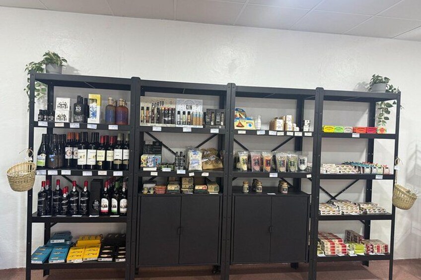A liquor store with shelves stocked with various bottles and boxes. 3