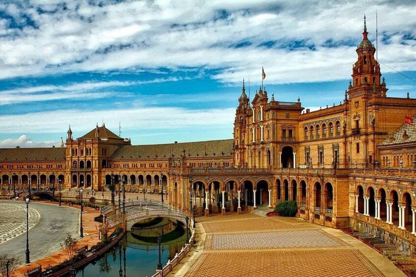 A large, historic building with arched walkways and a central courtyard. 4