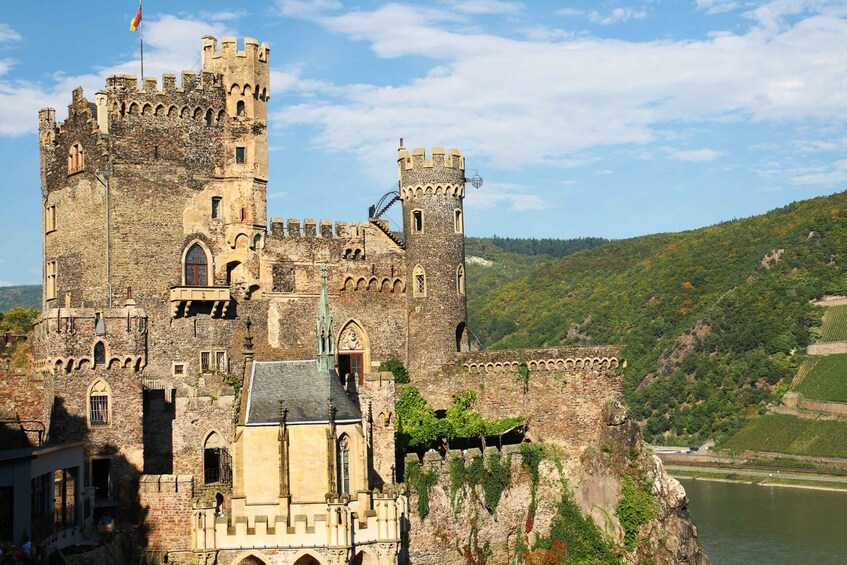 A historic castle with multiple towers and a river in the background. 4