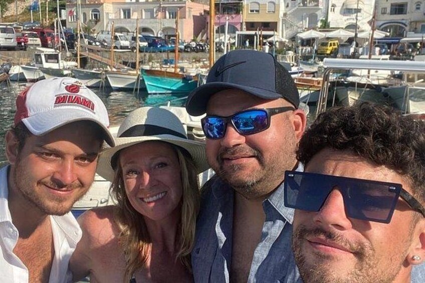 A group of people on a boat with a marina in the background. 2
