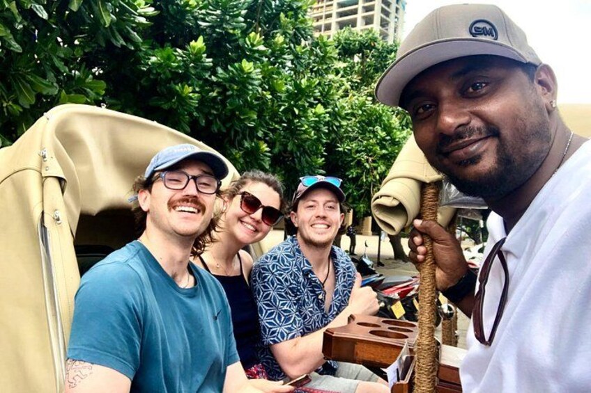 A group of people in a vehicle with a tree-lined background. 3