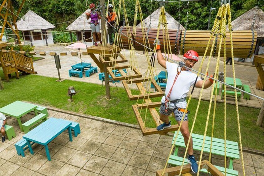 Guest climbing across the squares on the Gully Challenge Course at the Harrison's Cave Eco-Adventure Park 4