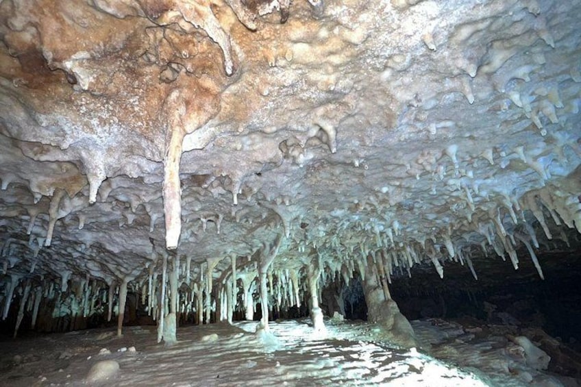 A cave with stalactites hanging from the ceiling and stalagmites rising from the ground. 2