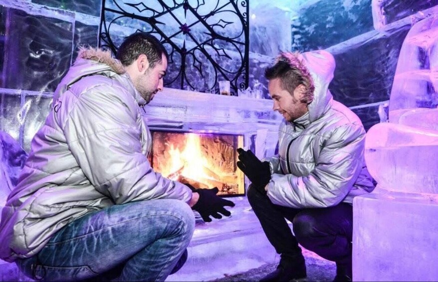 Two people sitting by an ice fireplace. 5
