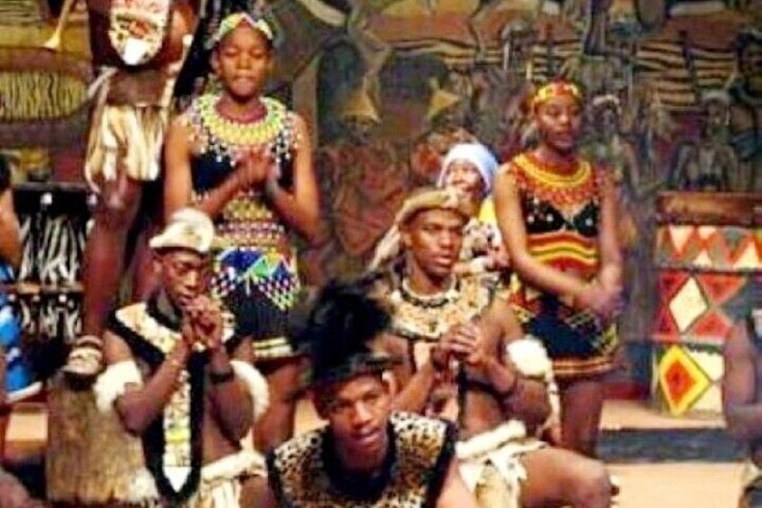 A group of people in traditional attire, possibly performing a cultural dance or ceremony. 1