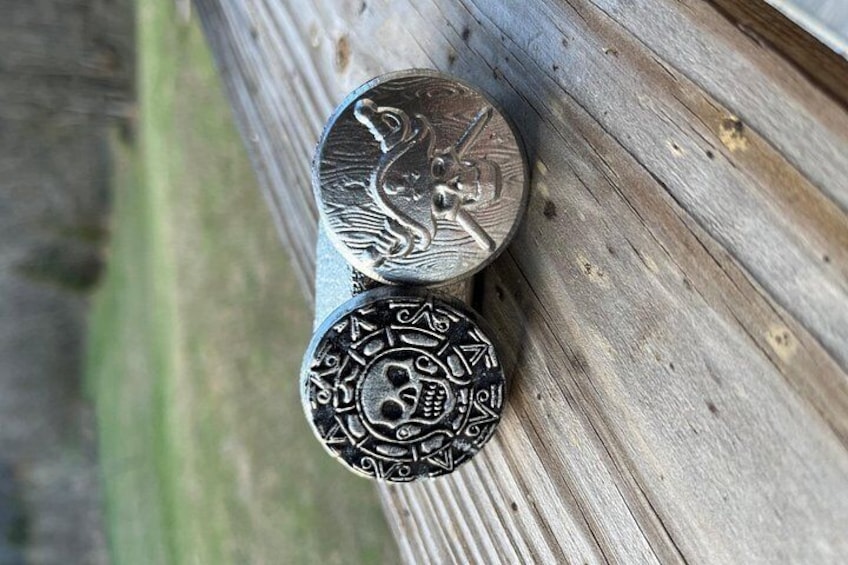 Dos objetos metálicos con diseños elaborados, sobre una superficie de madera. 5