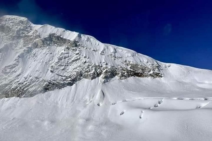 A snow-covered mountain with a clear sky. 4