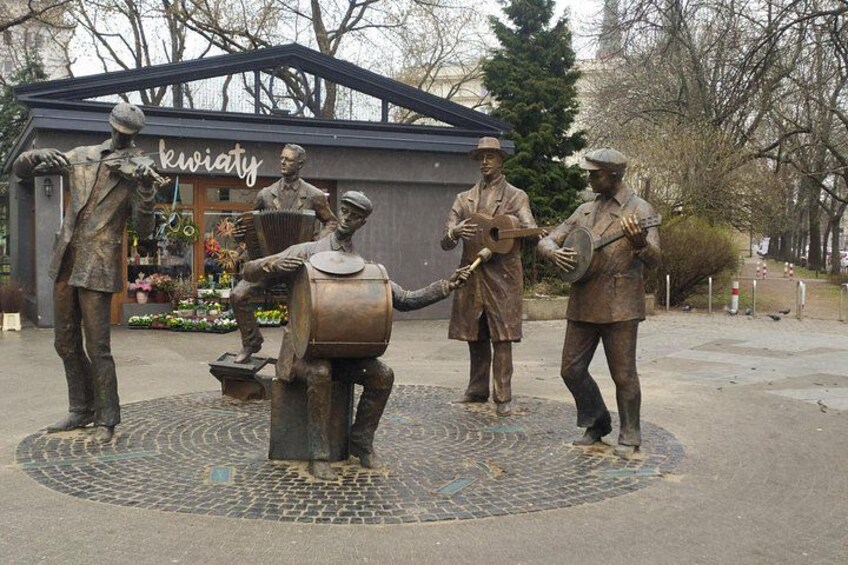 A bronze statue of musicians in a public square. 2