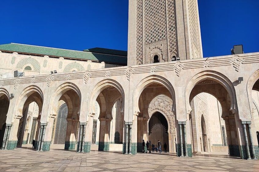 A historic building with arches and a tall tower. 2