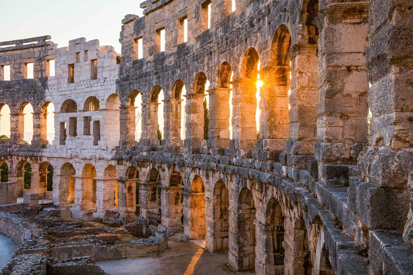 Ancient ruins with arches and columns, bathed in warm sunlight. 1