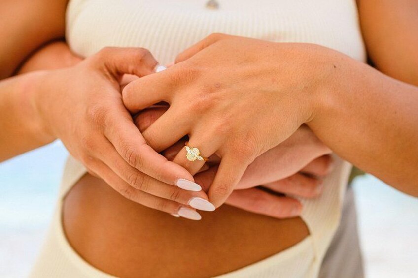 A close-up of hands holding a ring. 3