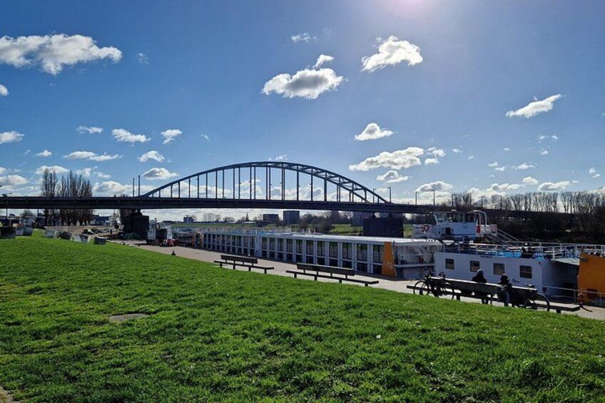 A park with a picnic area, a boat, and a bridge. 4