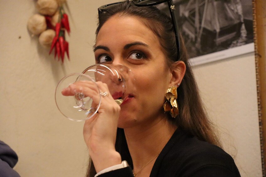 A person holding a wine glass. 3