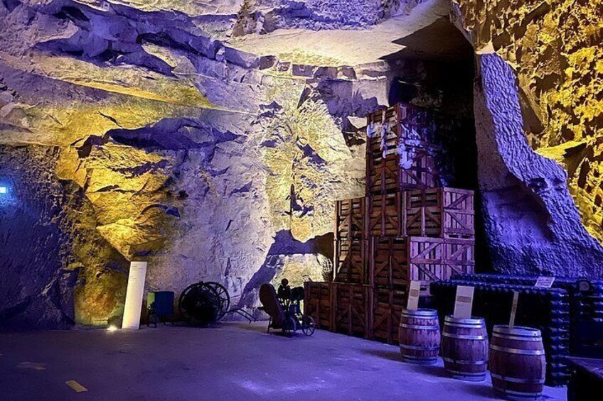 A cave with wooden structures and barrels, possibly for wine storage. 2