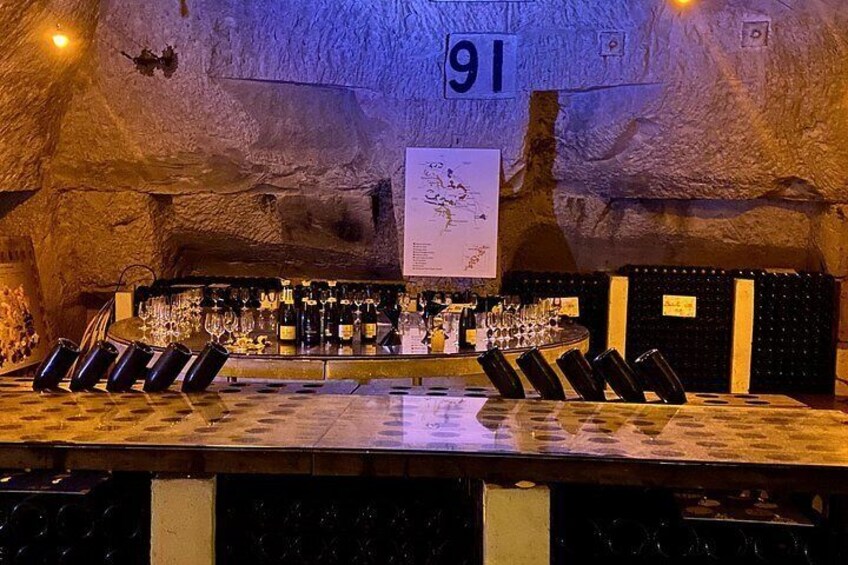 A bar with a number 91 sign, wine glasses, and bottles. 3
