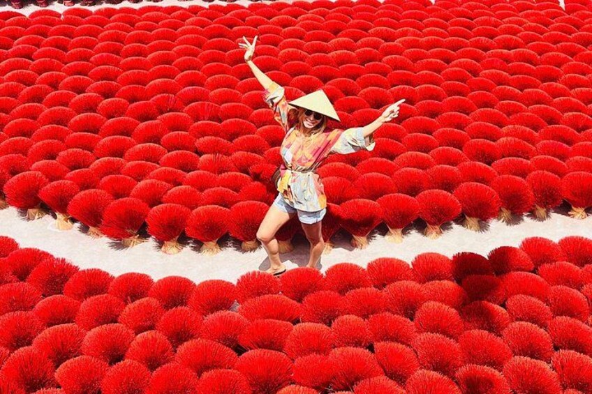 A person standing in a field of red spherical objects. 1