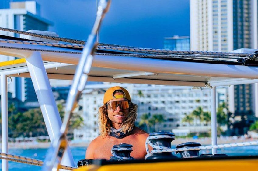 A person on a boat with a cityscape in the background. 3