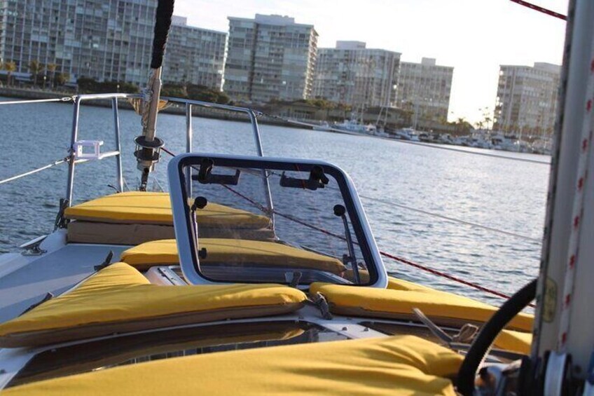 A boat's interior with yellow cushions and a metal railing. 4